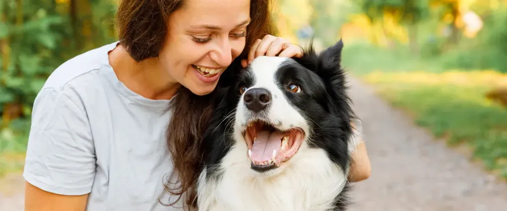Woman petting a dog on the head
